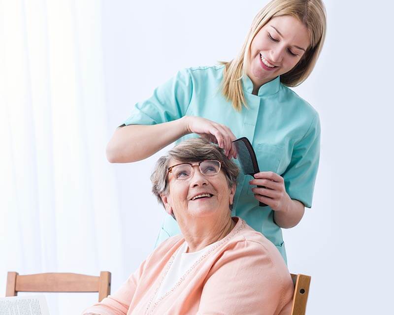 Caregiver brushing client's hair