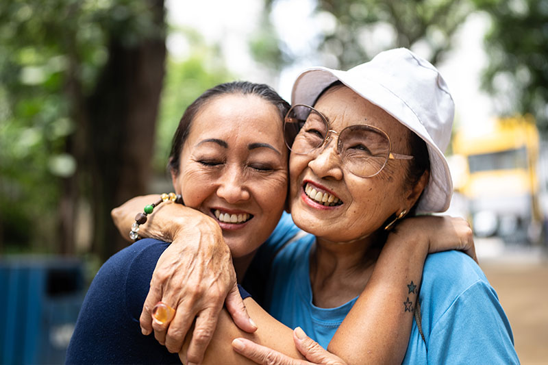 A woman hugs her aging mother as she learns more about communicating with compassion with people who have dementia.