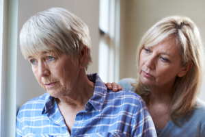 Alzheimer's Senior Woman With Adult Daughter At Home