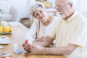 Senior couple looking at medicine bottles.