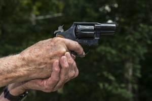 Hands aiming a pistol