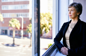 Shot of a thoughtful businesswoman looking out of an office window