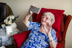 Senior woman on smart phone - technology for seniors - in home supportive services orange county