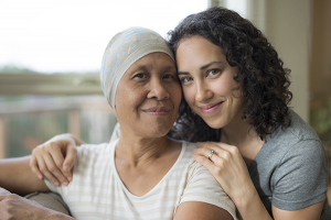 adult female hugging her mother who has cancer