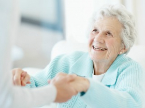 Smiling elderly woman accepts assistance to stand, home health care mission viejo ca