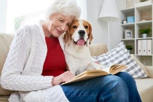 senior woman reading with dog