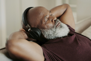 senior man resting and listening to headphones