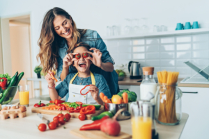 Caregiver in kitchen with child. 