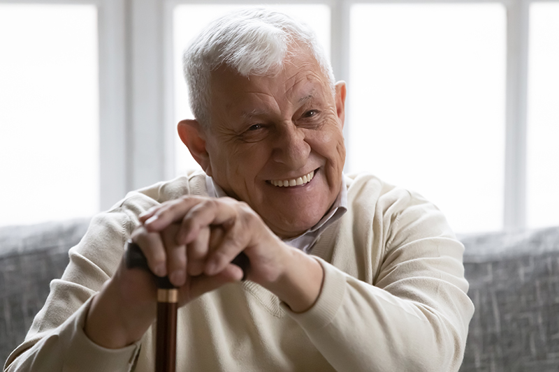 happy senior man with cane