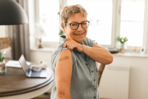 senior-woman-showing-bandage-on-arm