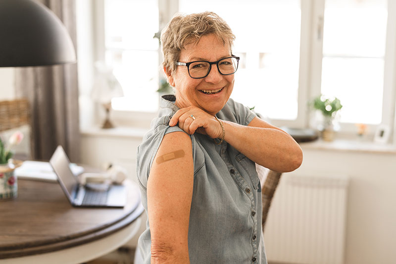 senior-woman-showing-bandage-on-arm