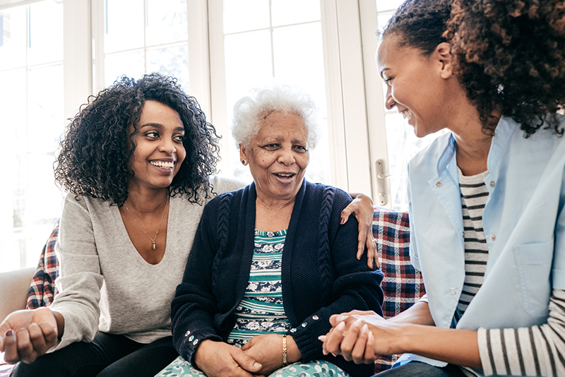 daughter and senior mother with caregiver