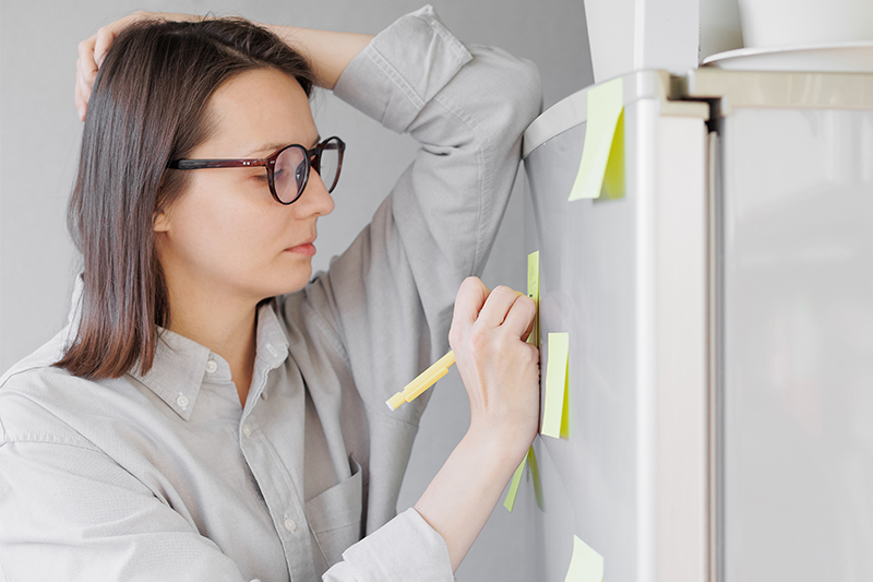 woman writing on post-it-notes