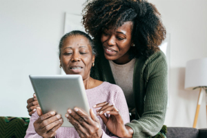 senior lady and caregiver looking at tablet