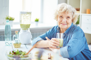 happy senior lady drinking smoothie