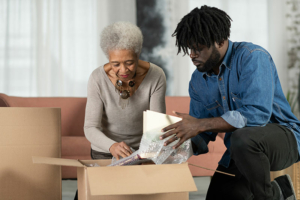 senior lady and son packing box