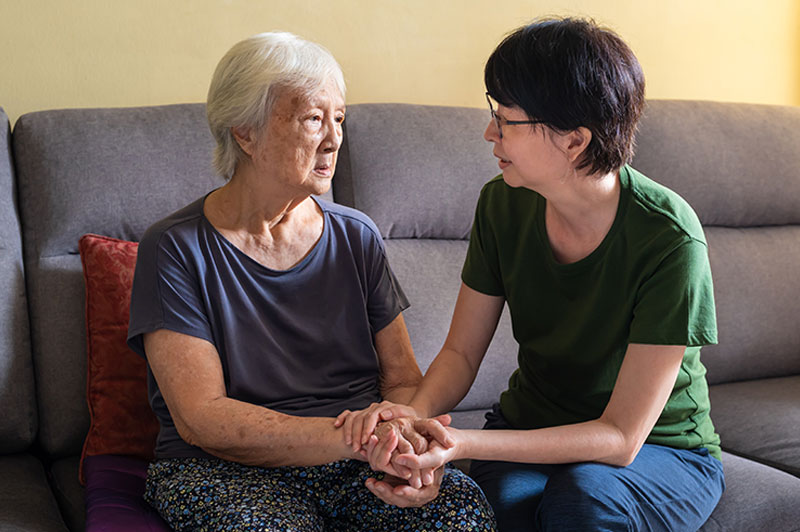 caregiver-comforting-senior-lady