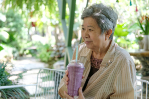 happy-senior-lady-drinking-smoothie