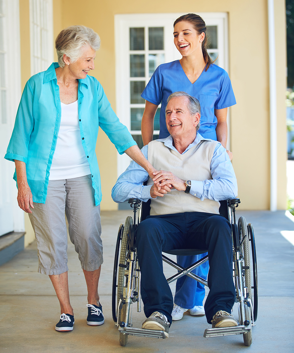 caregiver with senior couple outside