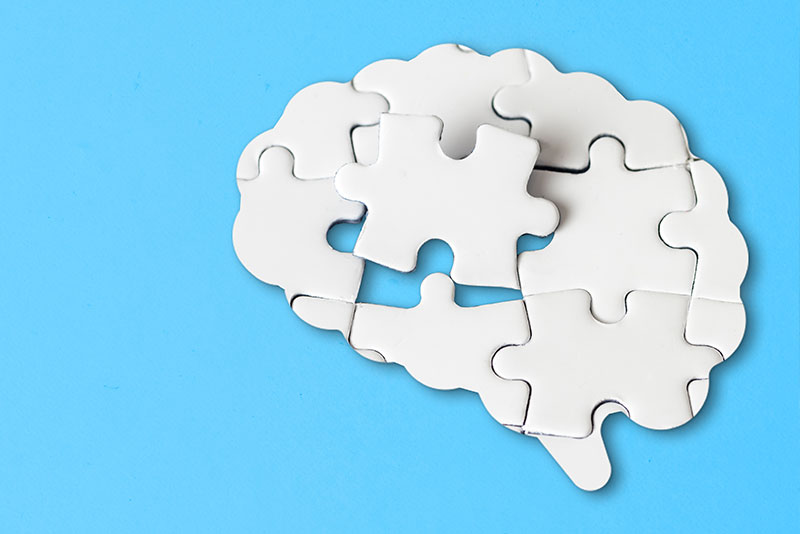 A puzzle of a brain shows one piece missing, alluding to the advancements in Alzheimer’s science that are still to come.