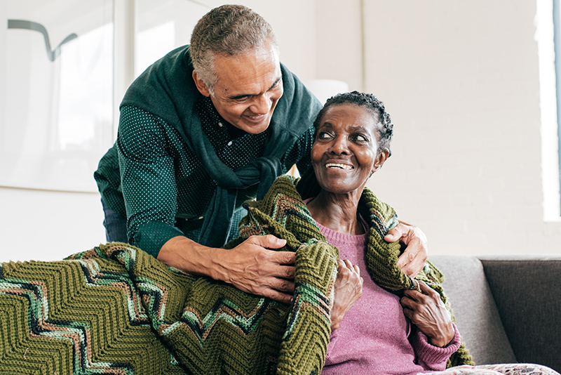 caregiver comforting his senior mother with Alzheimer's
